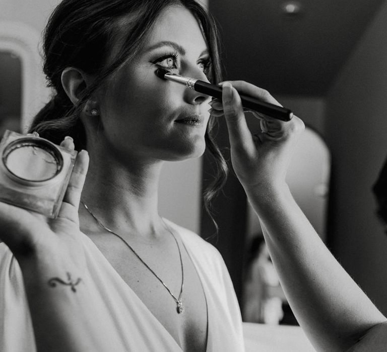 Bride gets her makeup done for her wedding day 