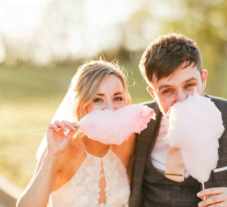 Bride and groom eat some of their candy floss at their wedding 