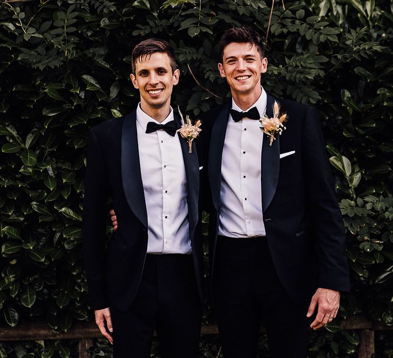 Groom and groomsmen wear black tie complete with pampas grass buttonholes 