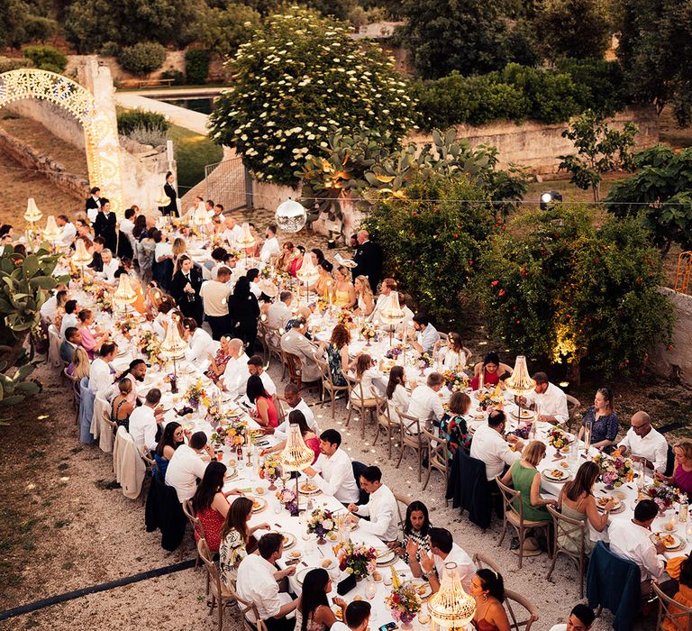 Eagle eye view of the wedding reception with banquet tables, chandelier installations, disco balls for the destination wedding 