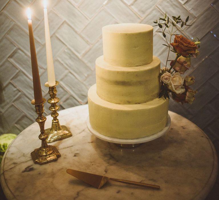 Plain white frosted wedding cake for a winter wedding 