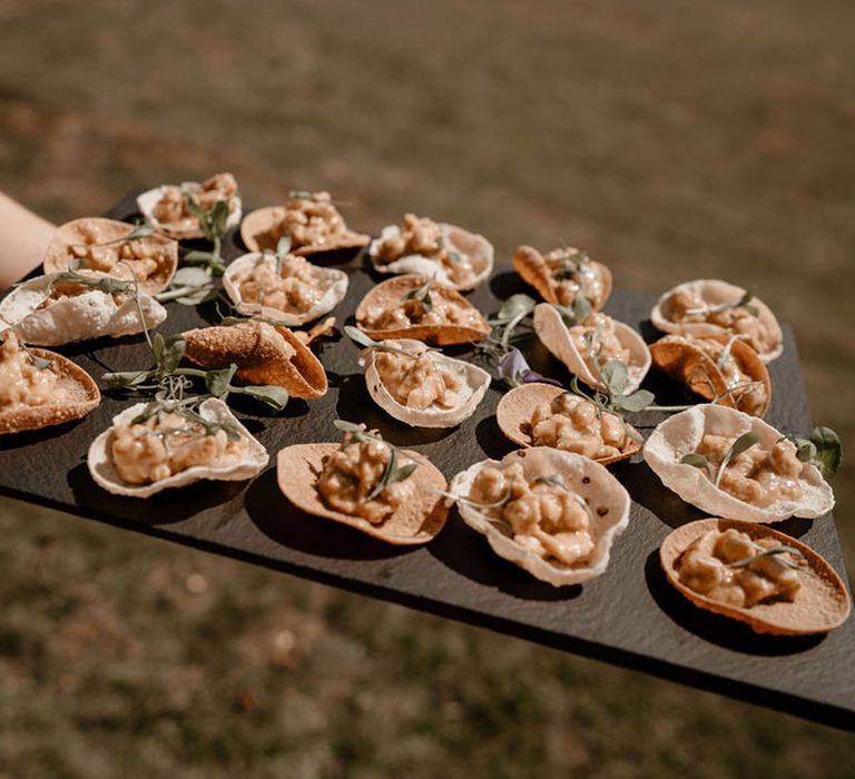 Canapés served on a black slate tray 