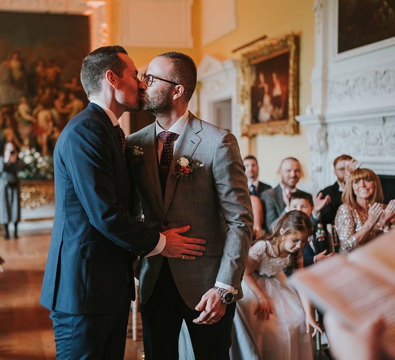 The grooms kiss as they share their first kiss as a married couple 