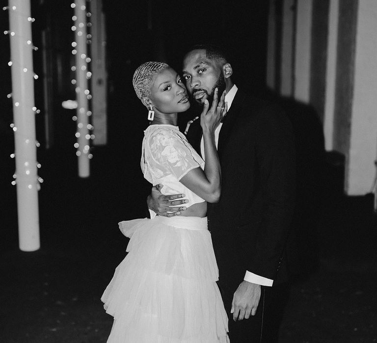 Bride and Groom dance under wedding fairy lights at industrial wedding venue