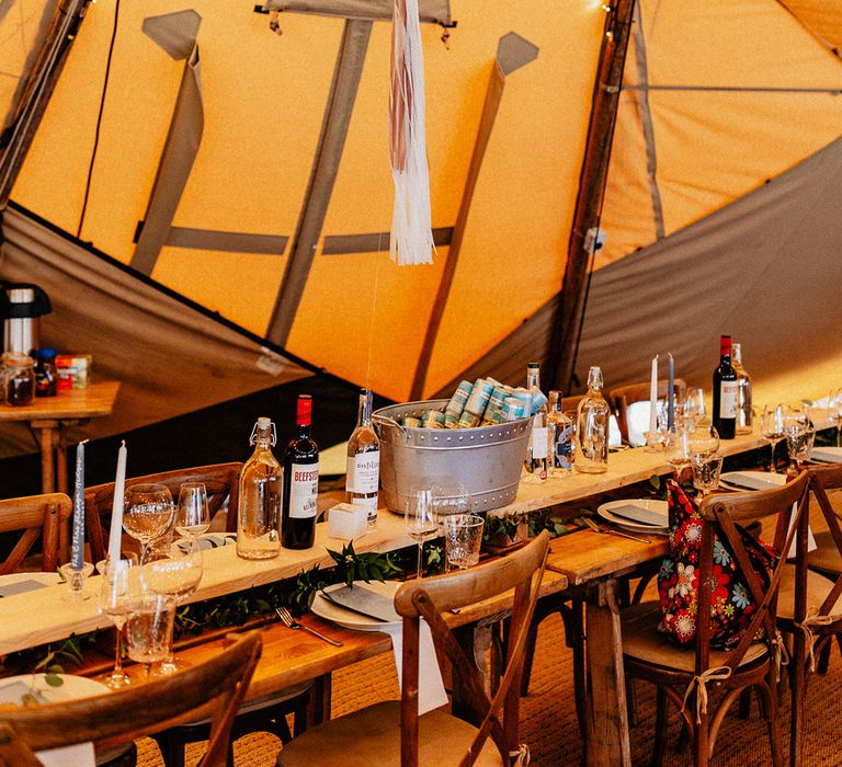 Tipi wedding reception with ballon table signs with tassels and plenty of alcohol for the wedding guests with gin stations