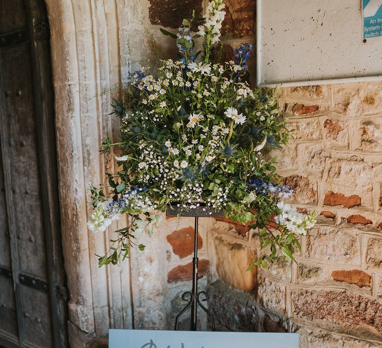 Blue wedding welcome sign with daisy wedding flowers 