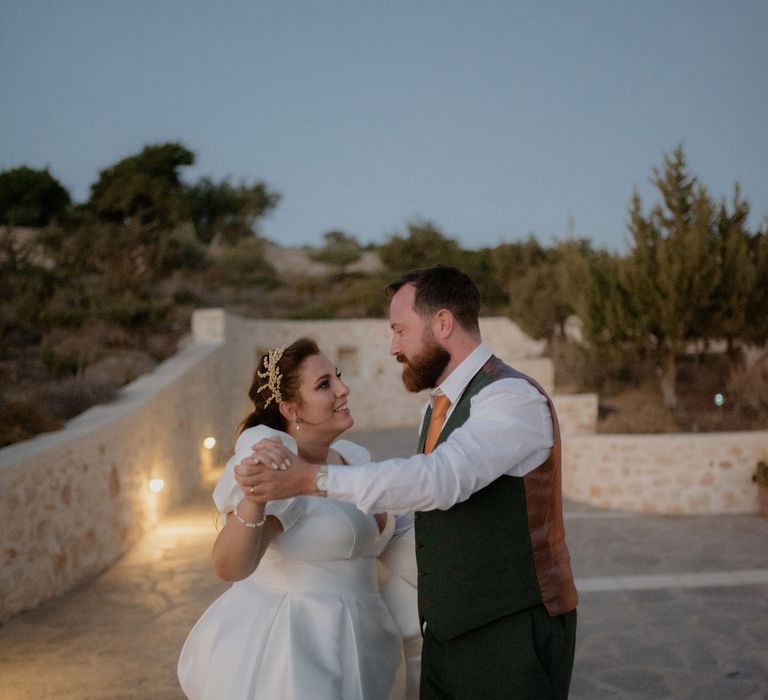 Bride and groom dancing during dusk at private villa wddding in Paros, Greece