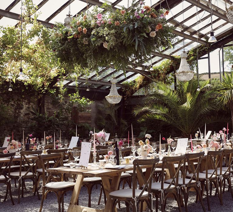 Stunning Anran wedding venue with disco balls, hanging floral installations and pink table decorations 