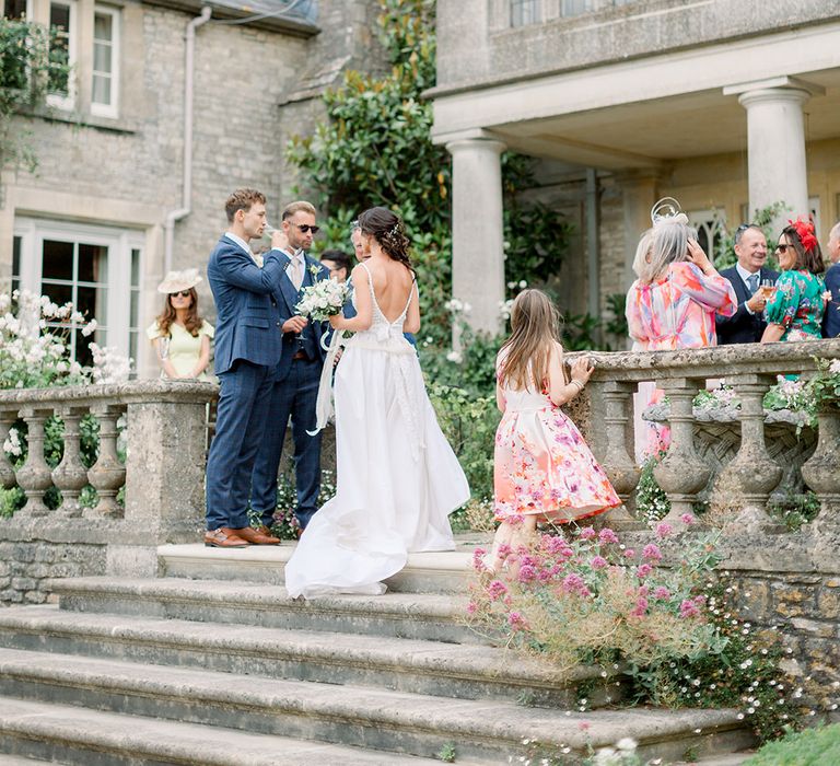 summer wedding drinks reception at Euridge Manor with bride in a fitted wedding dress talking to her wedding guests 