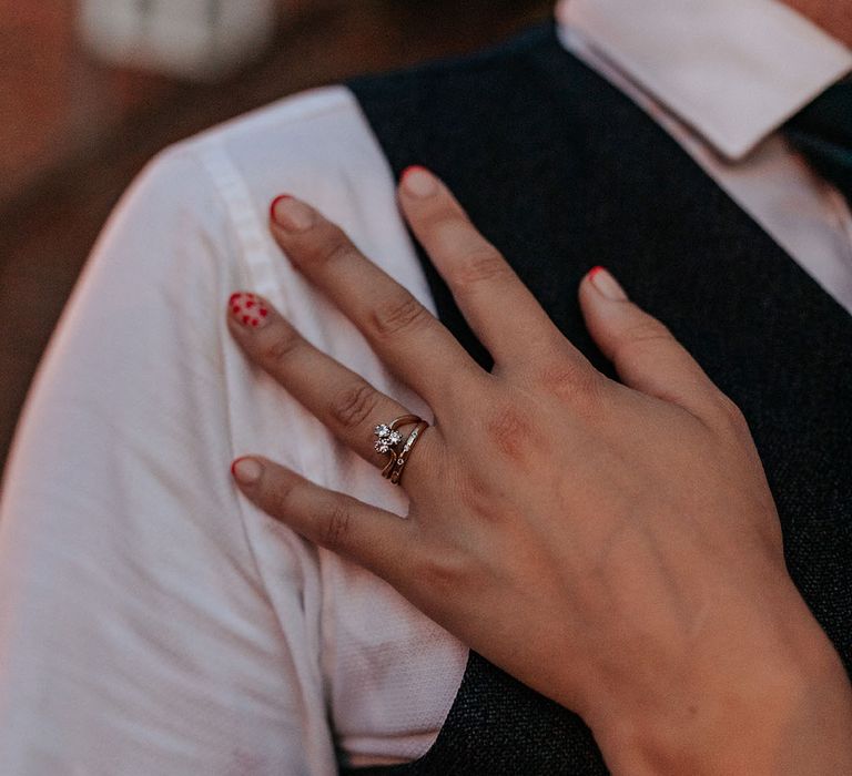 Bold red nail art for bride with colourful red French tip and red hearts design on accent nail 