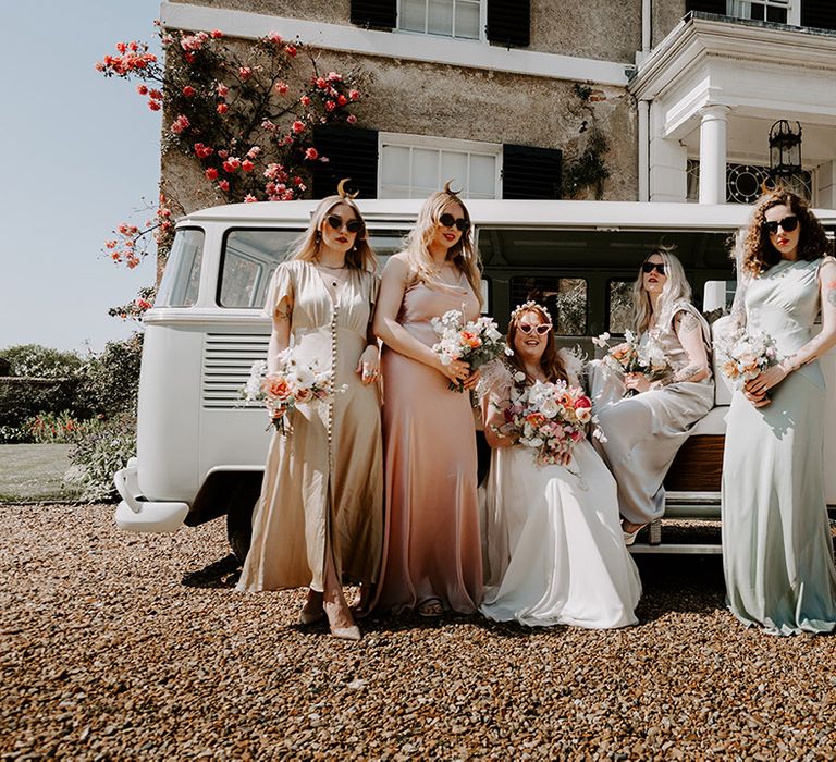 Moon maidens in pastel bridesmaid dresses next to the vintage campervan 