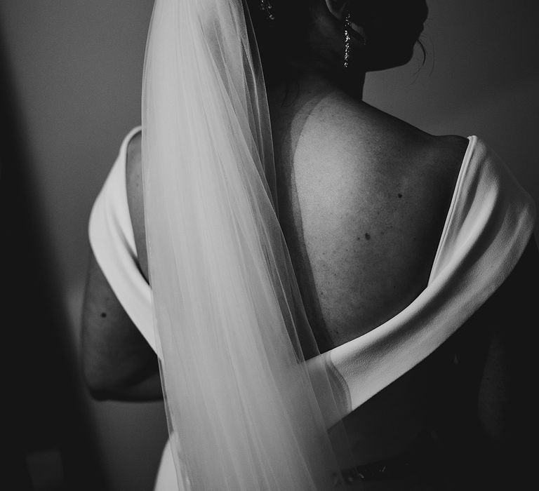 Bride wearing traditional wedding veil for classic yet rustic barn wedding 