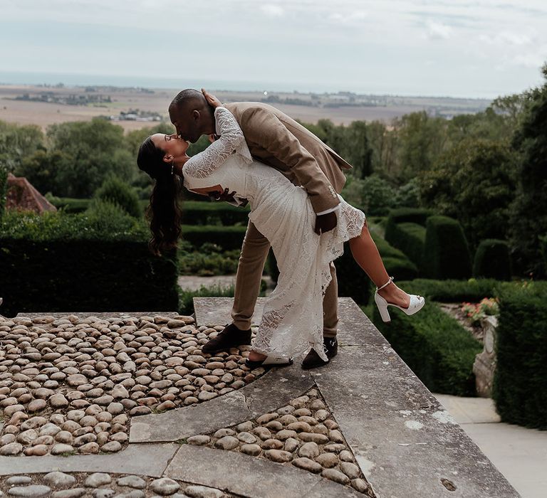 The groom spins the bride into an epic sweeping kiss at safari wedding 