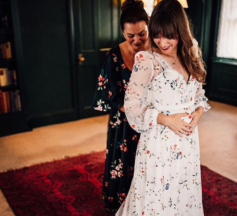 Bride wearing long sleeve sheer wedding dress with floral embroidery 