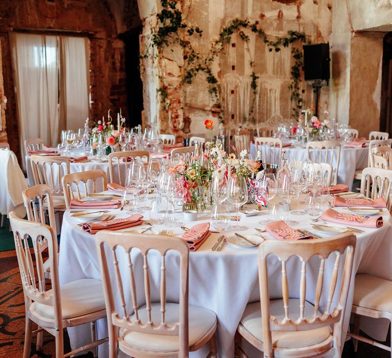 Pink wedding table decor and flowers with pink napkins and menu stationery 