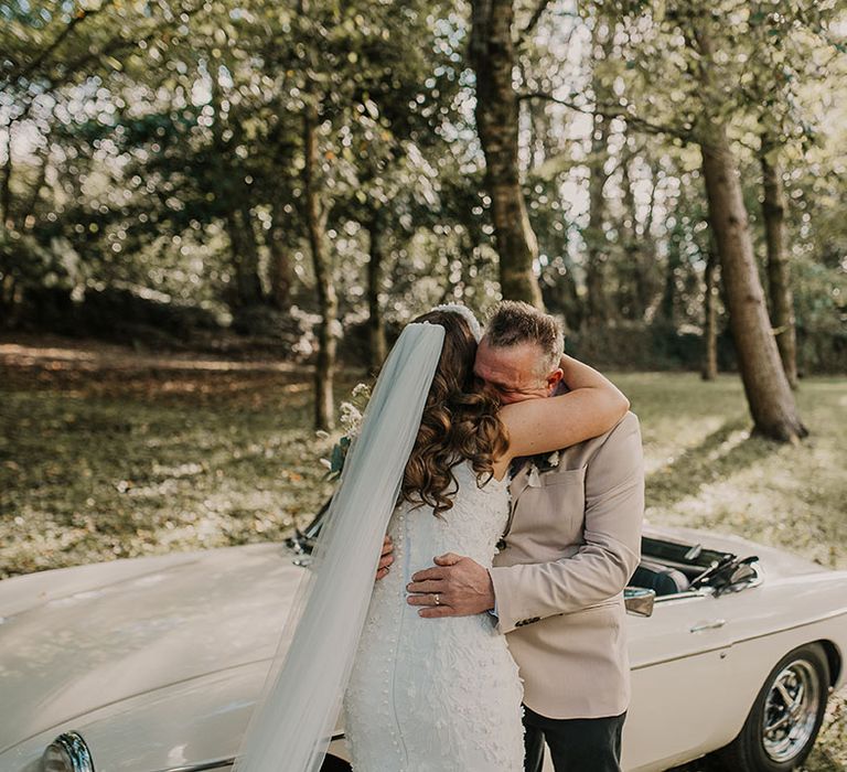 Father of the bride cries as he sees the bride in her wedding dress for the first time 