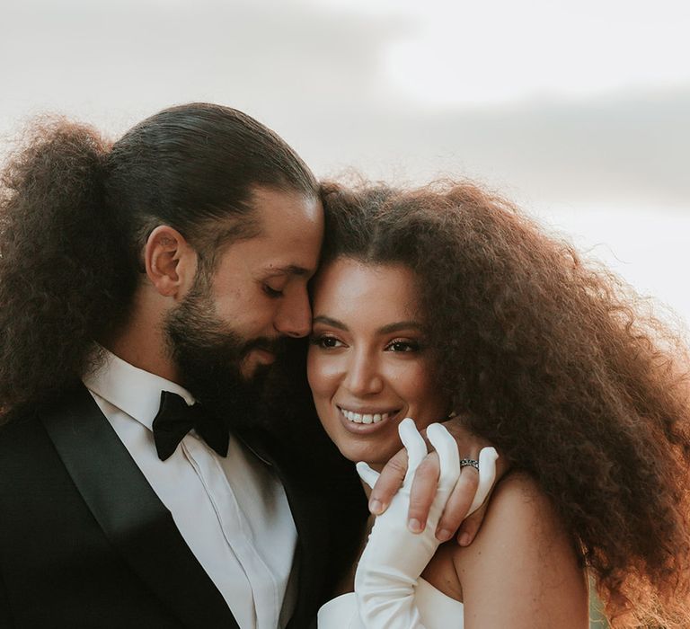 Bride and groom posing together at golden hour 