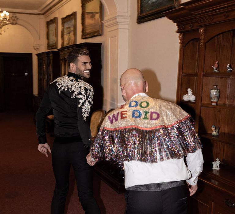 Two grooms wearing sparkly wedding reception outfits for their wedding 