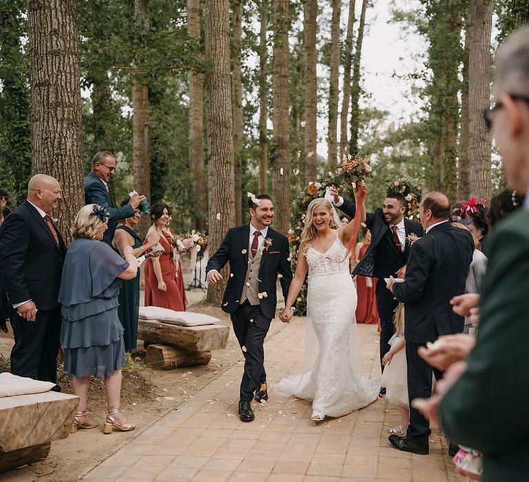 Bride and groom wall back down the aisle as a married couple at their Sicily wedding ceremony 