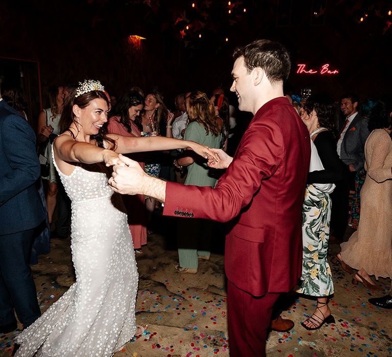 The bride and groom have their first dance together 