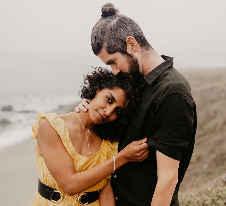 Intimate coastal portrait with bride in yellow dress