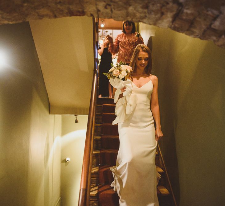 Bride walking down the stairs before her wedding day in Chelsea 