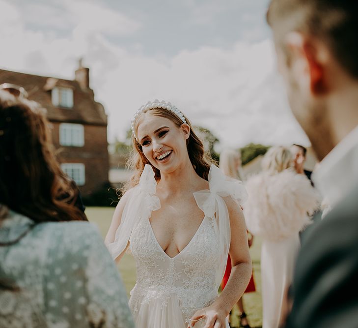 Bride in Inbal Dror wedding dress and pearl headband 