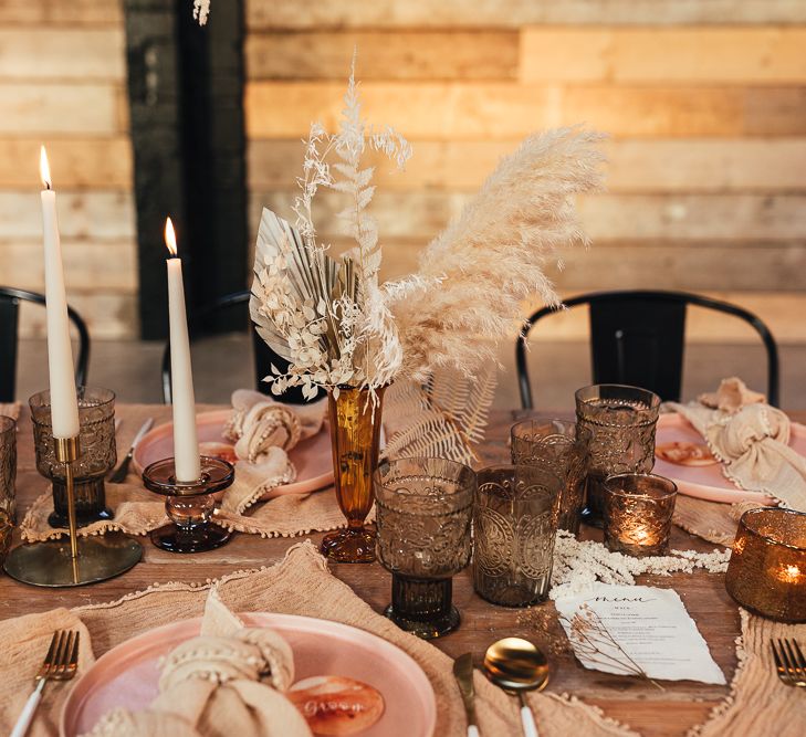 Wedding table decor with coloured glass, charger plates and dried flowers 