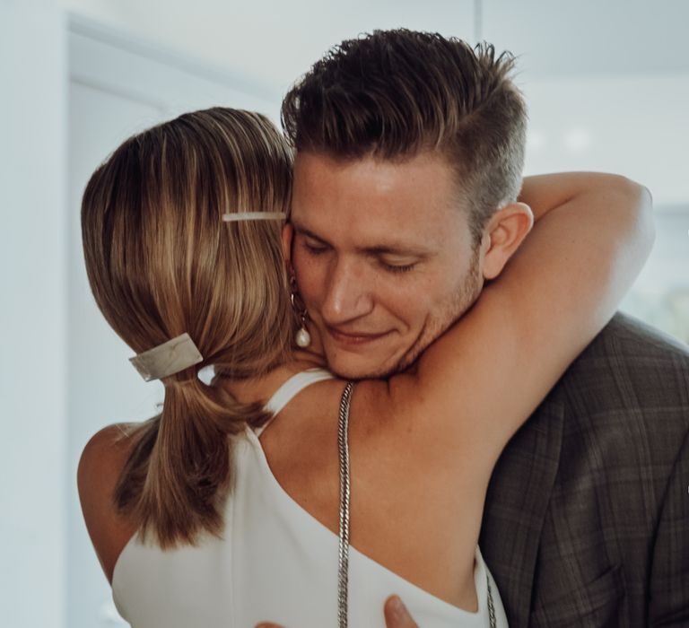 Groom embracing his bride during the first look 