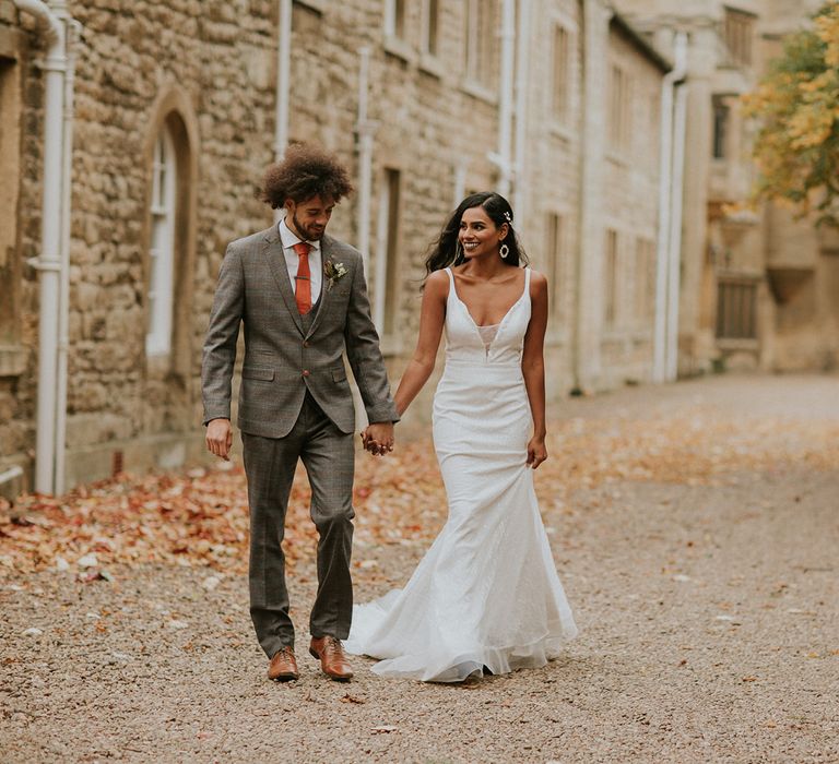 Bride and groom holding hands at Hooton Pagnell Hall 