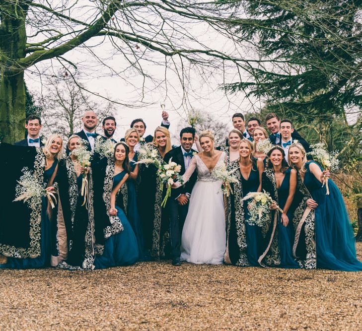 Wedding party portrait with bridesmaids in teal dresses 