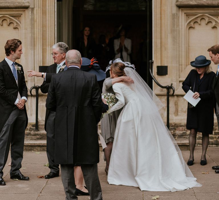 Bride hugging wedding guest at church wedding