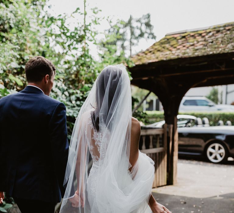 Bride & groom walk together on wedding day 