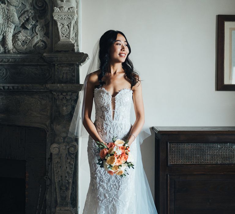 Bride in strapless lace wedding dress on her wedding morning 