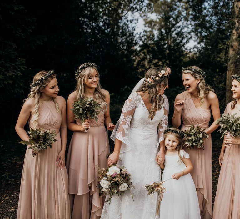 Laughing bridal party and boho bride pose outside at highland wedding in Glencoe