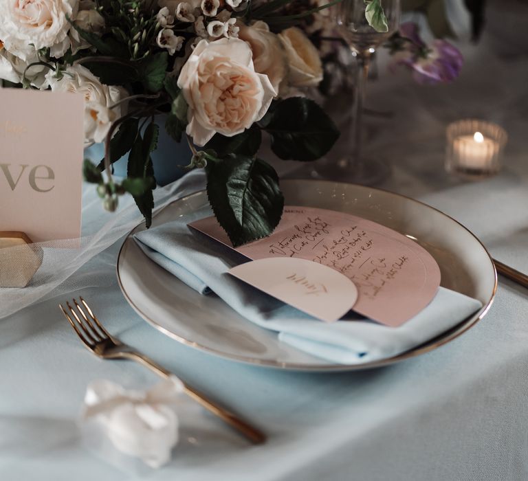 White and gold place settings with pink wedding stationery