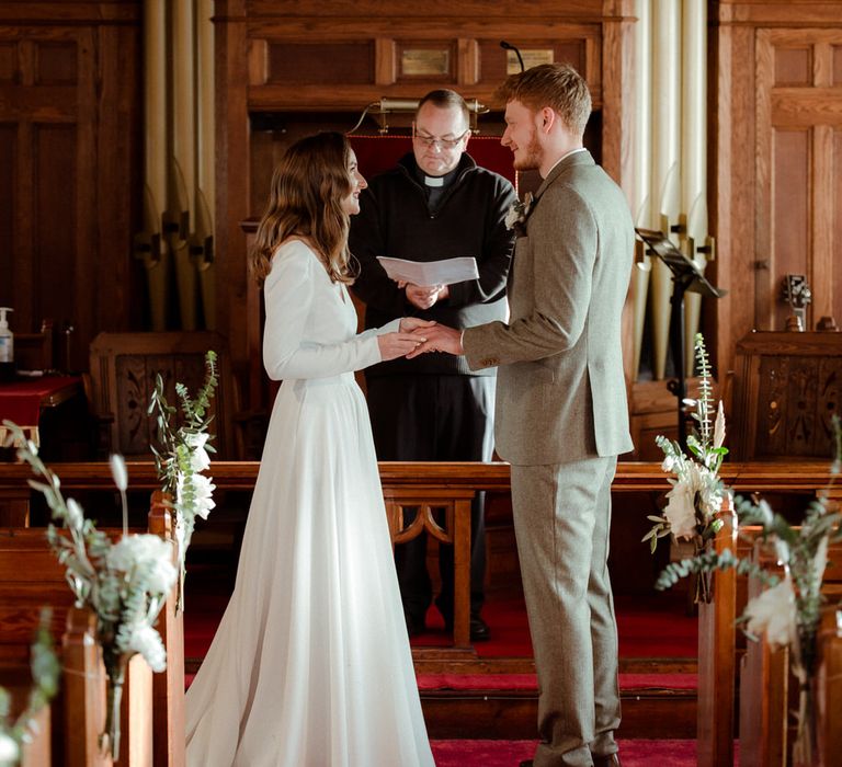 The bride and groom getting married at their Methodist wedding ceremony