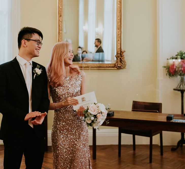 Bride and groom smiling at their intimate Chelsea Town hall wedding ceremony 