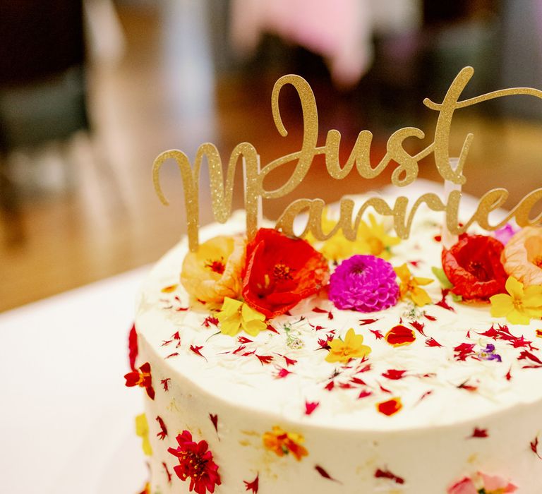 Single tier buttercream wedding cake with edible flowers and Just married cake topper