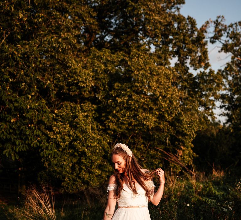 Bride stands beneath the trees for outdoor garden wedding