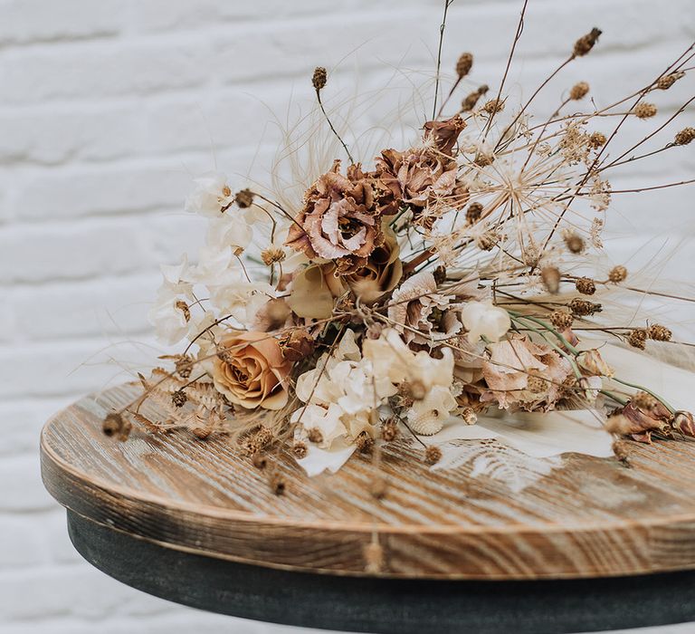 Neutral dried flower bouquet of roses, carnations and wild grasses