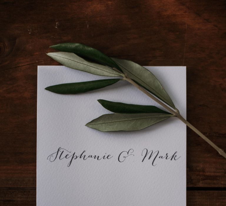 Classic white wedding stationery complete with sprig of rosemary 