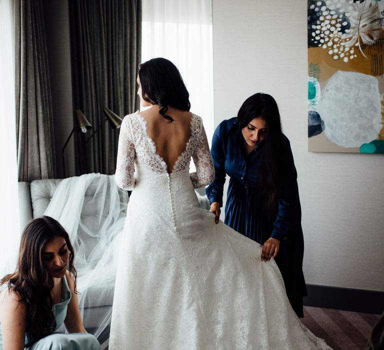 Bride wears white wedding gown from Pronovias with low back and lace bodice