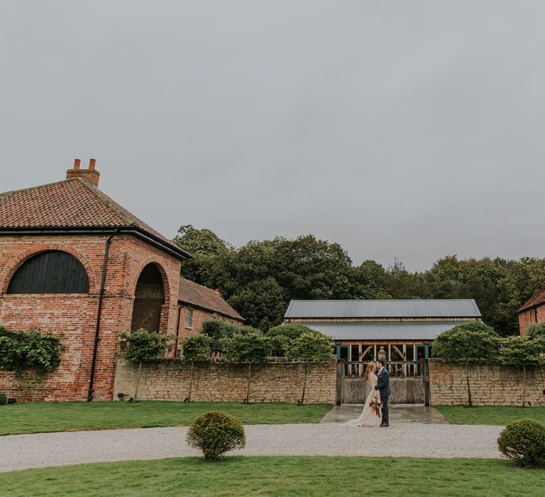 Bride and groom portrait outside their rustic barn wedding venue, Hazel Gap