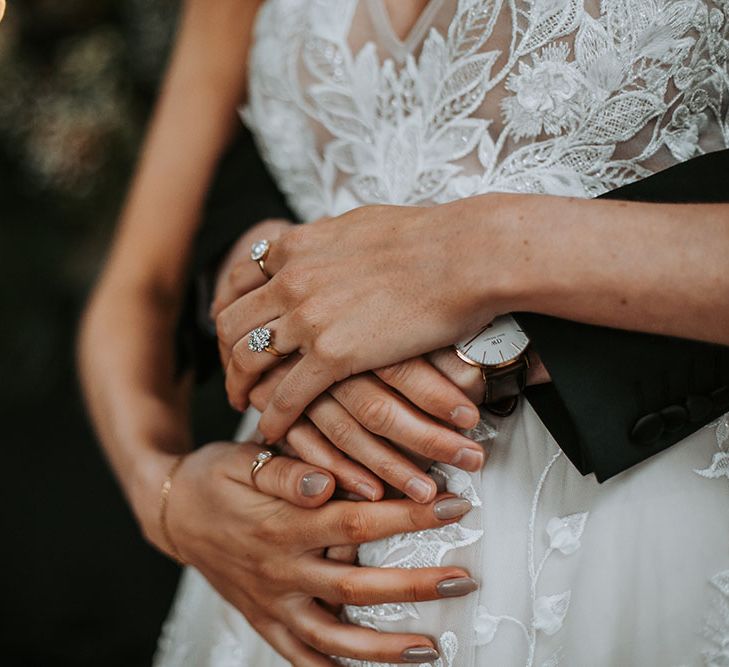 bride with taupe wedding day nails and diamond engagement ring