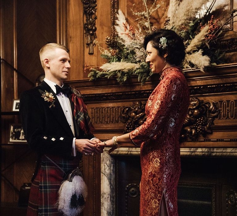 Groom in tartan and bride in red cheongsam dress