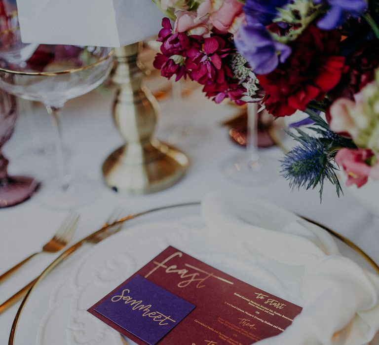 Place setting with gold rimmed tableware and braille menu card 