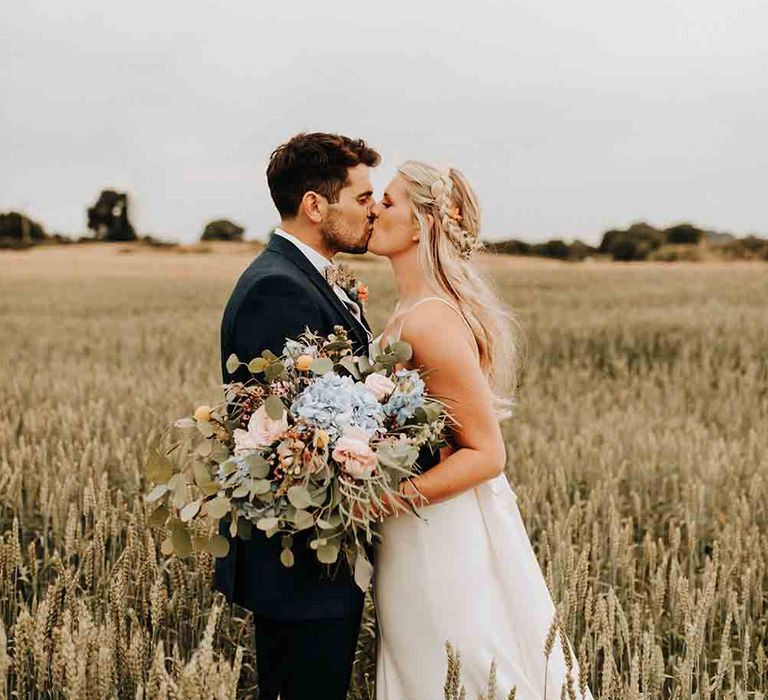 Bride and groom at barn wedding with brass band wedding entertainment