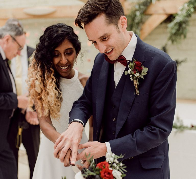 Bride & groom cut their wedding cake | Joshua Gooding Photography