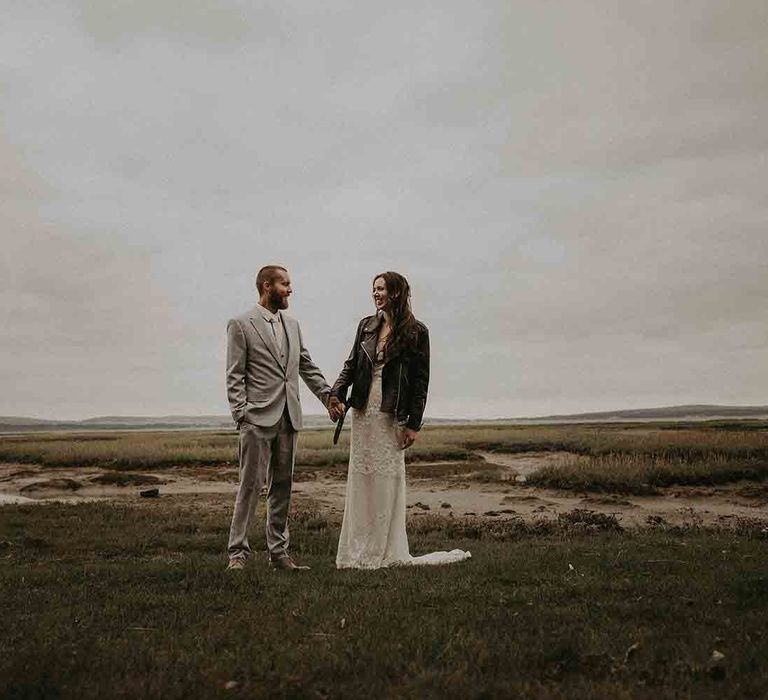 Bride covers up with oversized leather jacket 